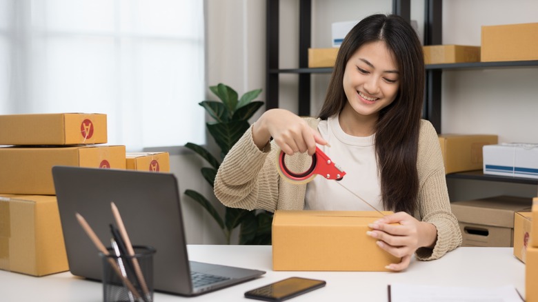 Person taping up a box