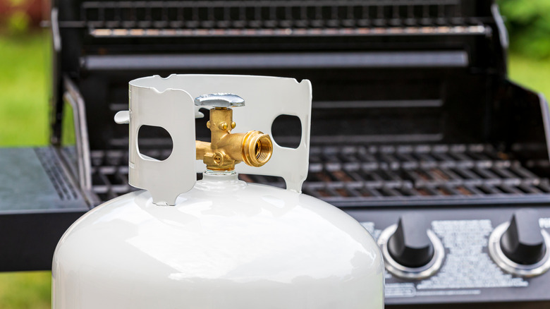 Propane tank in front of a grill