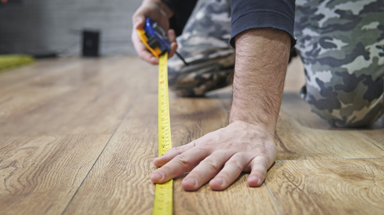 Person measuring floor