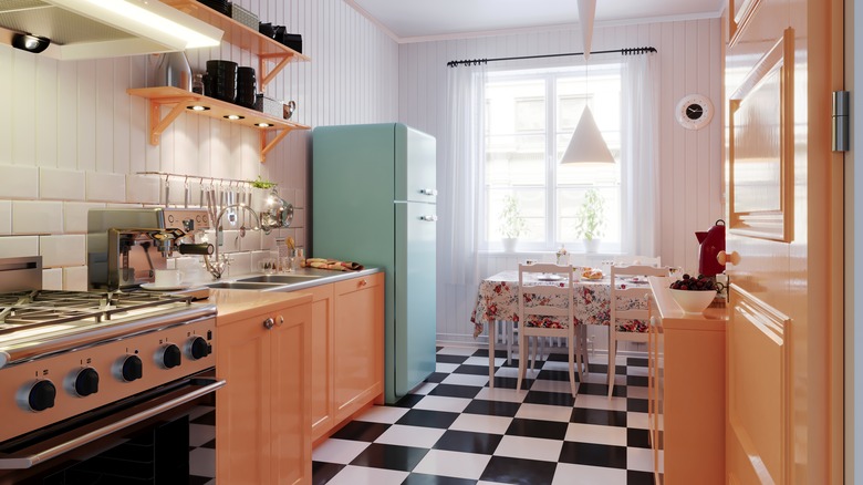 A mid-century modern styled kitchen with black and white checked floors, retro appliances, and a subway tile backsplash