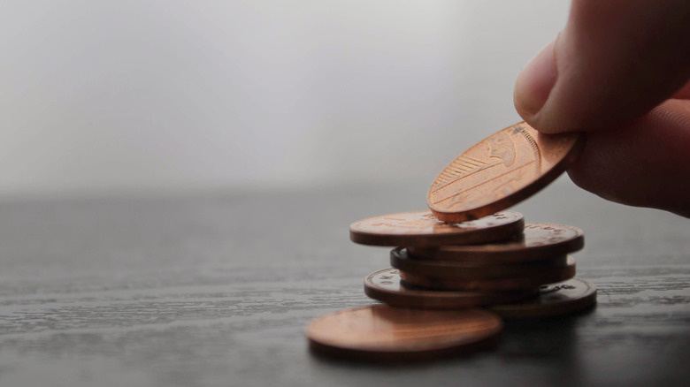 person picking up a penny