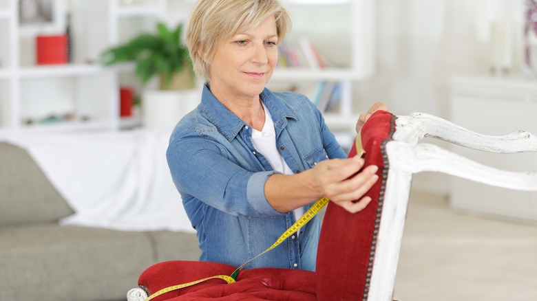 Person reupholstering chair