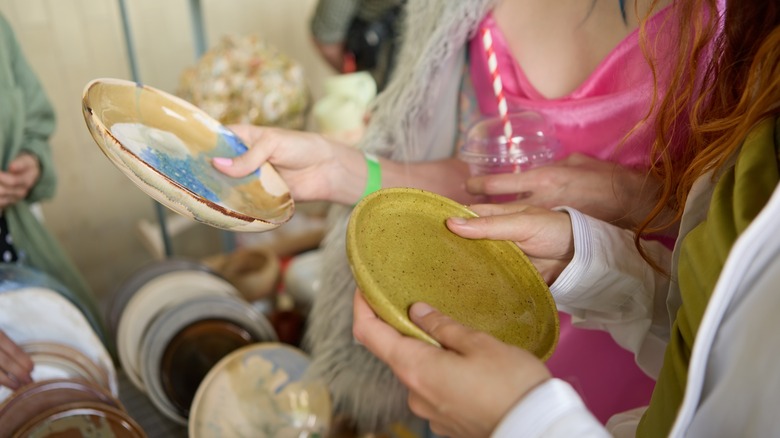 Two people holding plates 