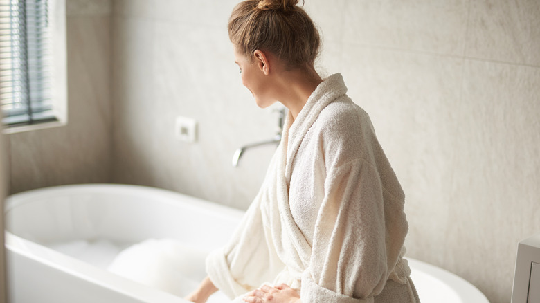 Woman prepares to take bath 