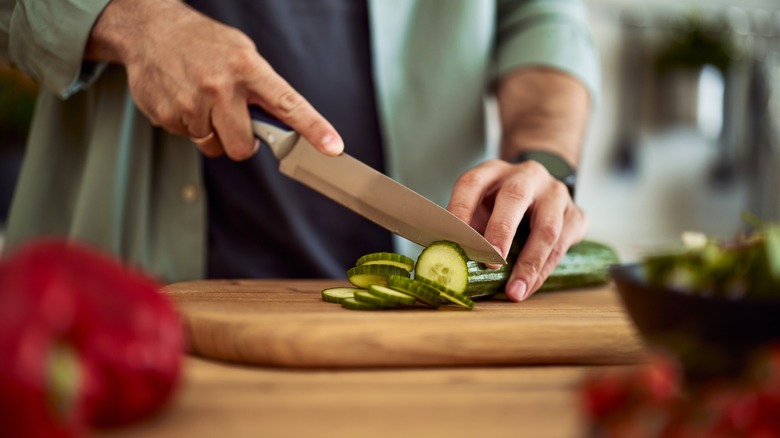 Man slicing cucumber