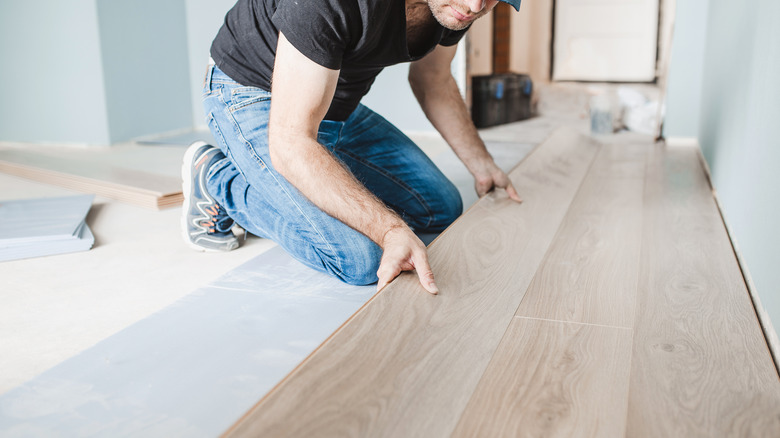 Person installing laminate flooring