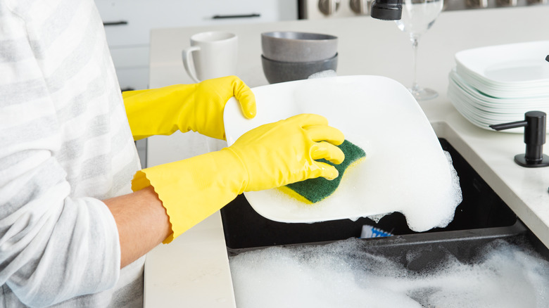 individual washing a plate