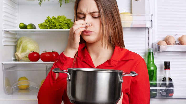 woman holding smelly pot 