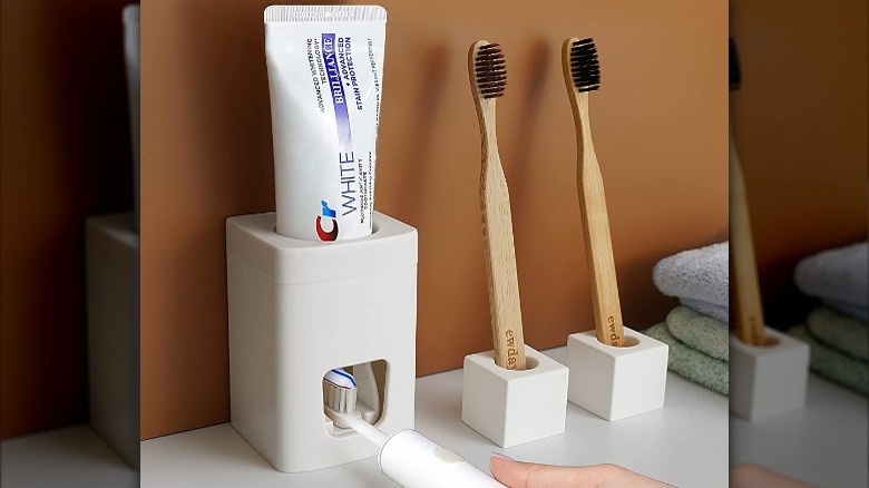 white automatic toothpaste dispenser