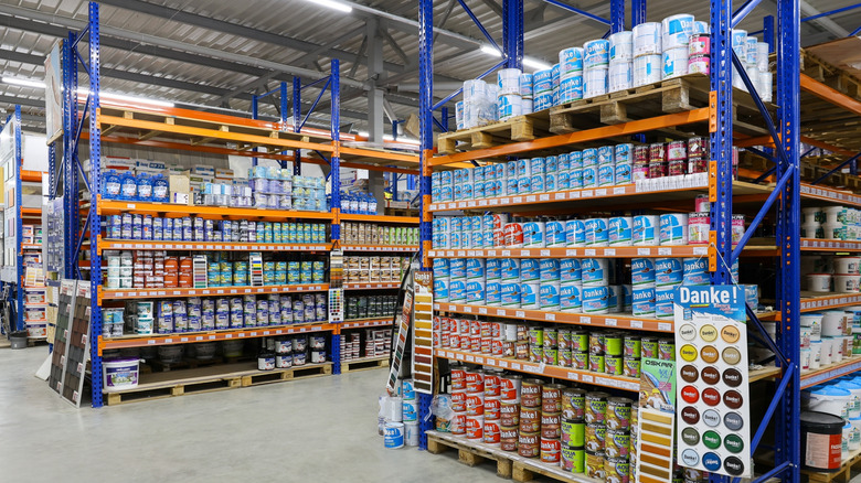 Cans of paint on a shelf in a store