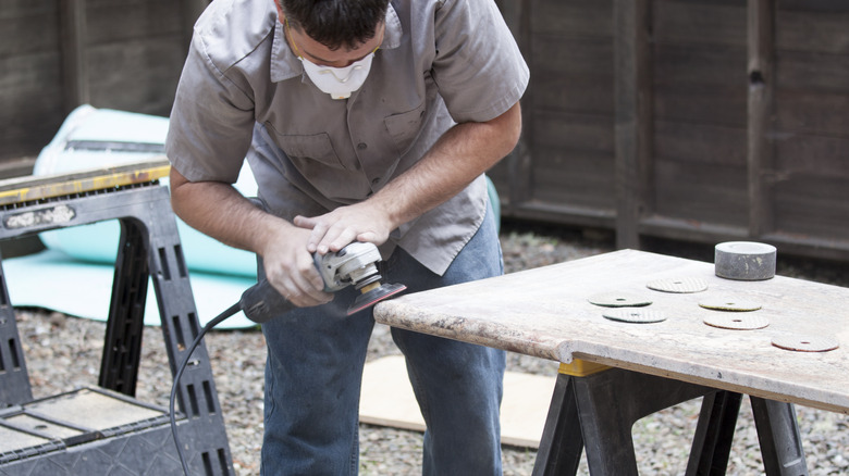 man working on granite countertop