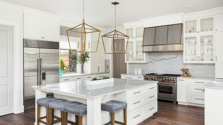 gold lantern pendants in white kitchen