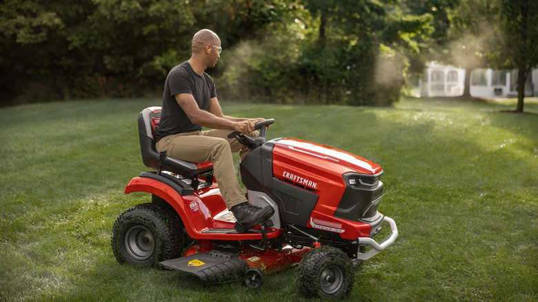 man riding lawn mower