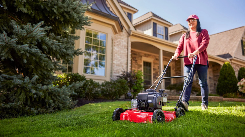 woman pushing craftsman lawn mower