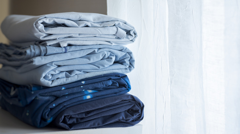 stack of blue bedsheets