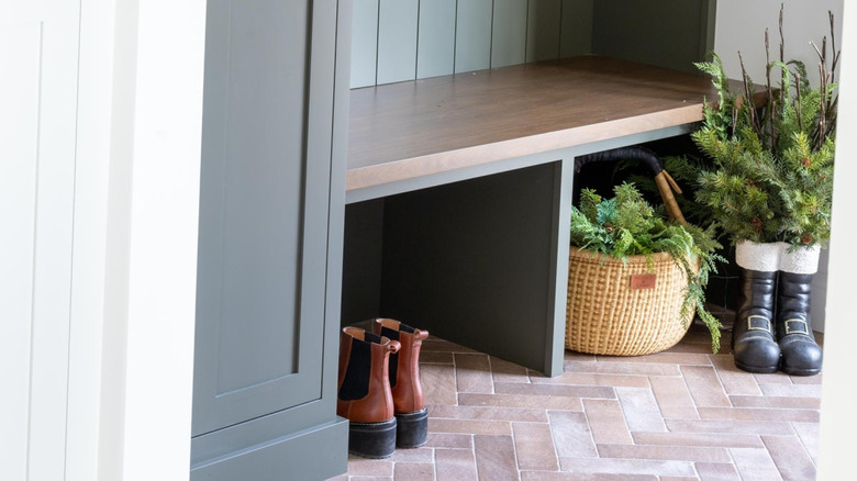 winter boots and greenery in mudroom