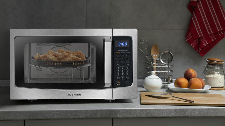 Toshiba 4-in-1 microwave oven on a kitchen counter with food inside