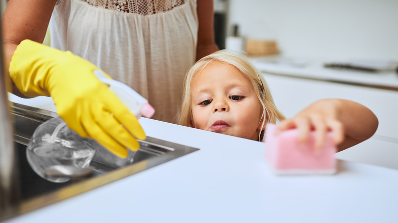 Mother and daughter clean together