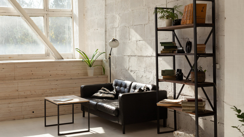 black sofa paired with brick