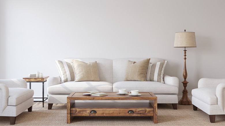 white couch with beige pillows 