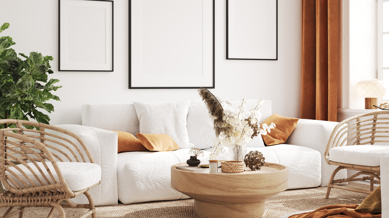white couch with orange pillows