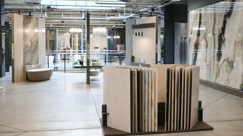 A bathroom showroom with a large format tile selection in the foreground