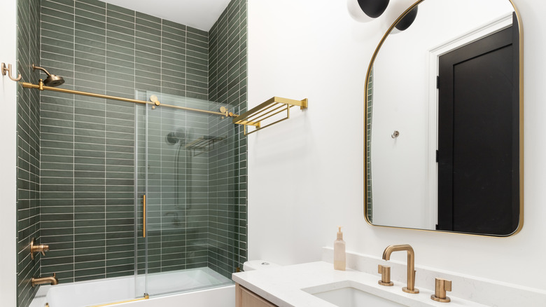 Olive green shower tiles in bathroom