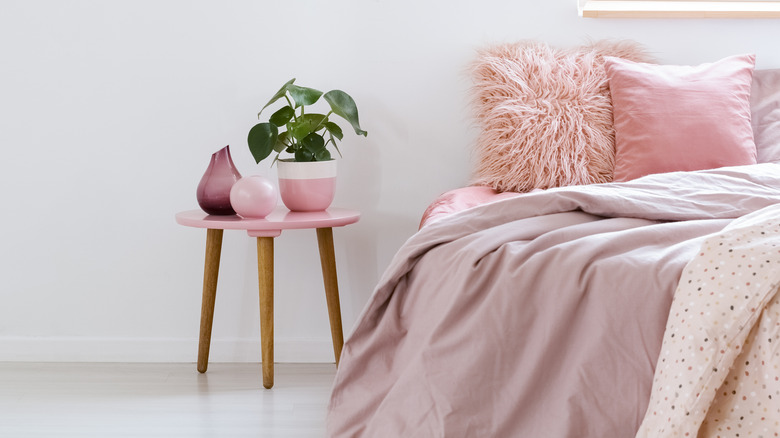 pink bed with nightstand