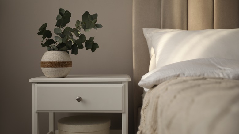 white nightstand next to bed