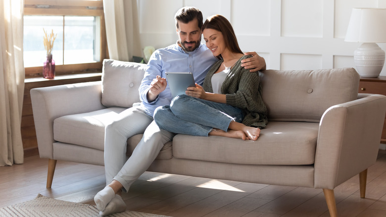 Couple browses store on tablet