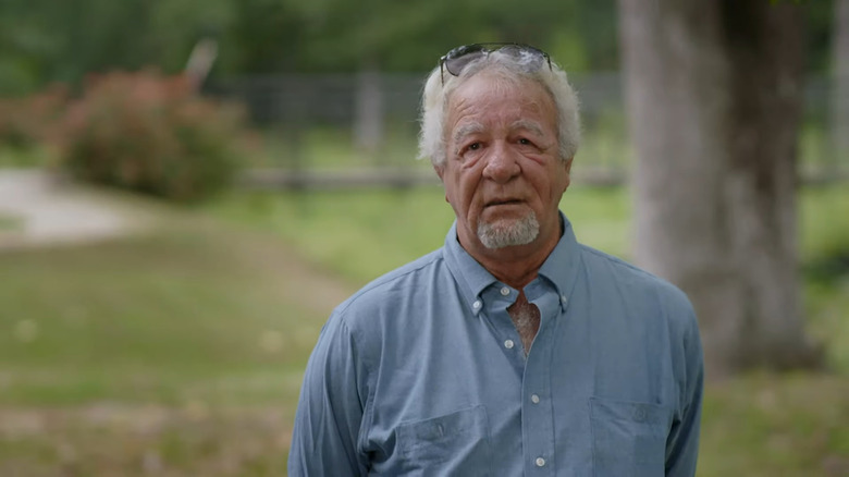 John Combe speaking to camera