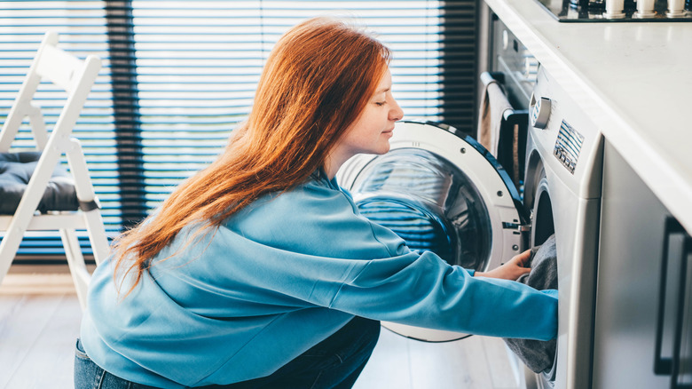 Woman using a washing machine