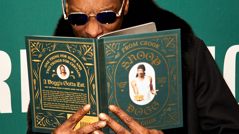 Snoop Dogg holding his book, From Crook to Cook