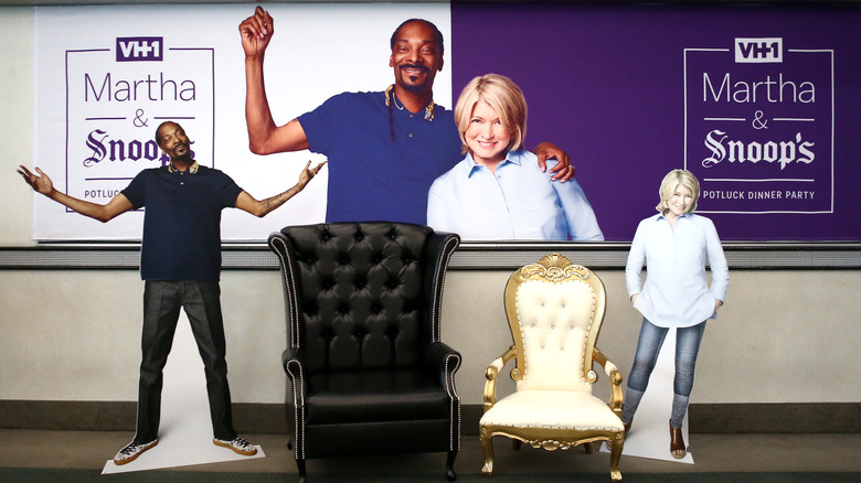 Cardboard cutouts of Snoop Dogg and Martha Stewart in front of potluck sign