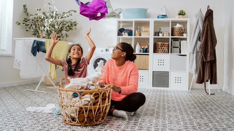 Woman and child folding laundry