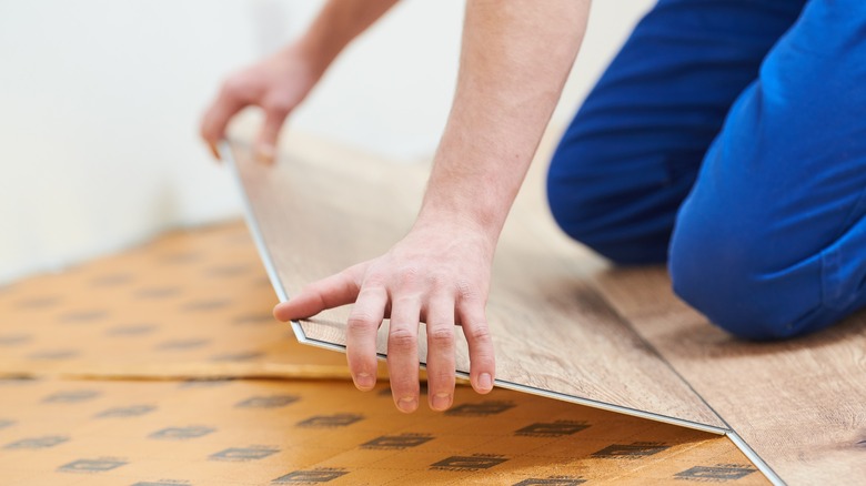 person installing vinyl flooring