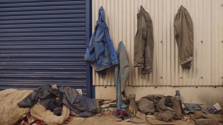 dirty jean work jackets hanging outside