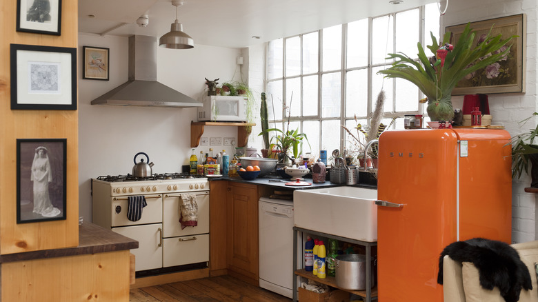 Freestanding kitchen with an orange refrigerator