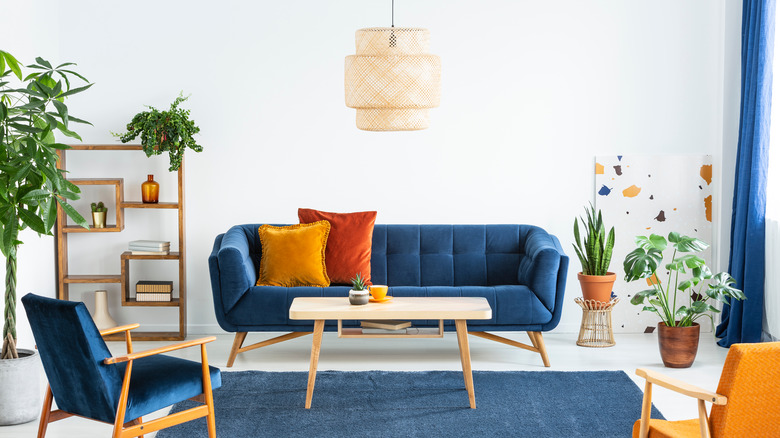 pendant light above blue sofa