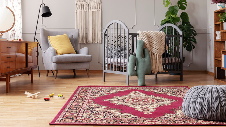 red decorative rug in a nursery 