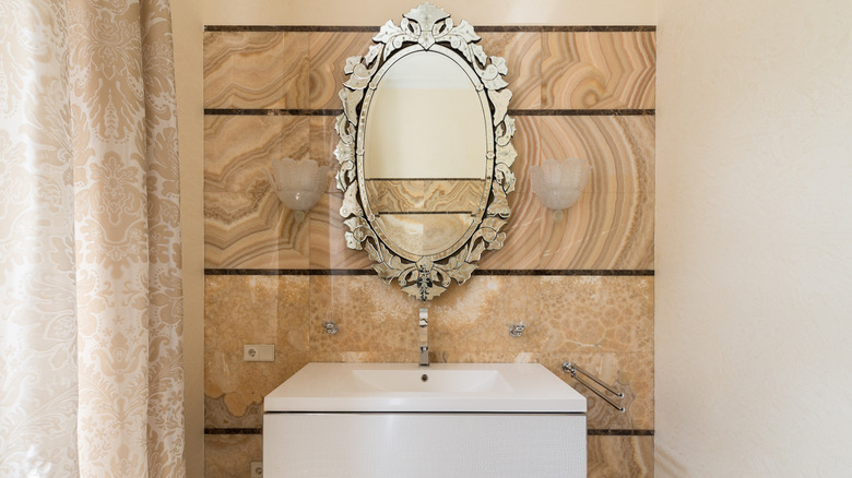 Wall sconces by bathroom mirror