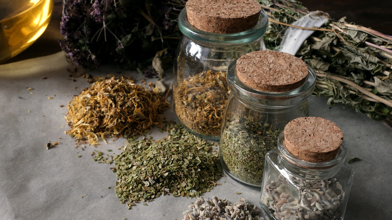 apothecary jars with dried herbs