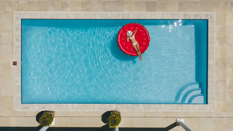 woman in pool on raft