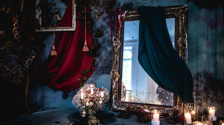 dark room with mirror and candles