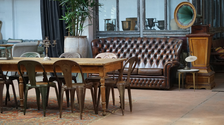 brown couch with long wooden dining table 