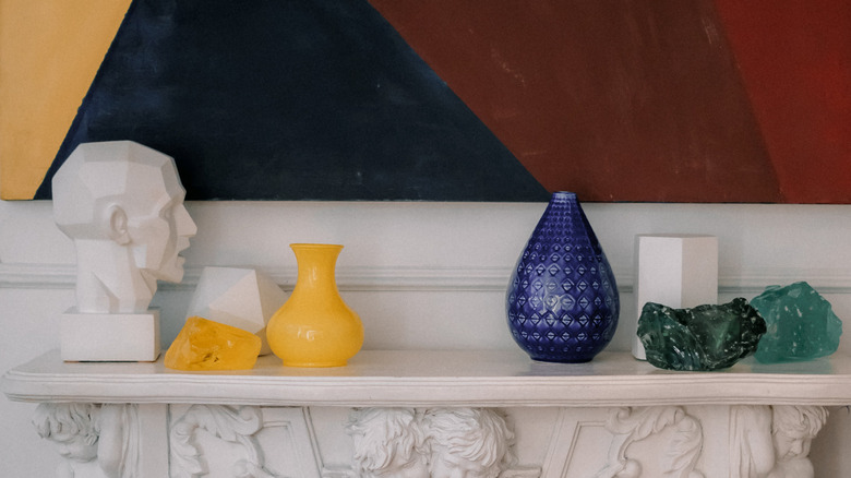 yellow and blue statues on mantel