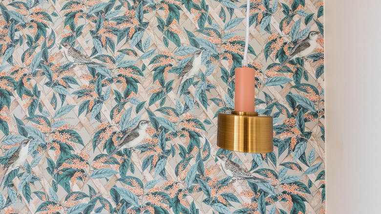 peach and blue wallpaper behind lamp