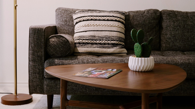 embroidered pillow on gray couch