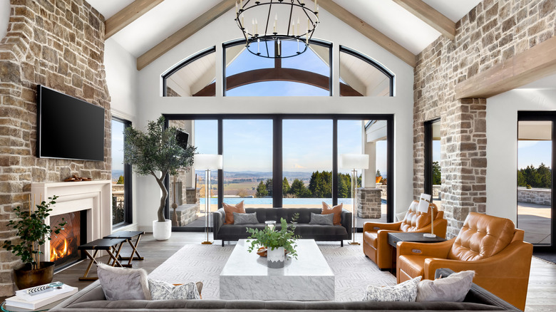 chandelier in living room with brick