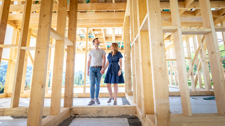 couple holding hands new construction